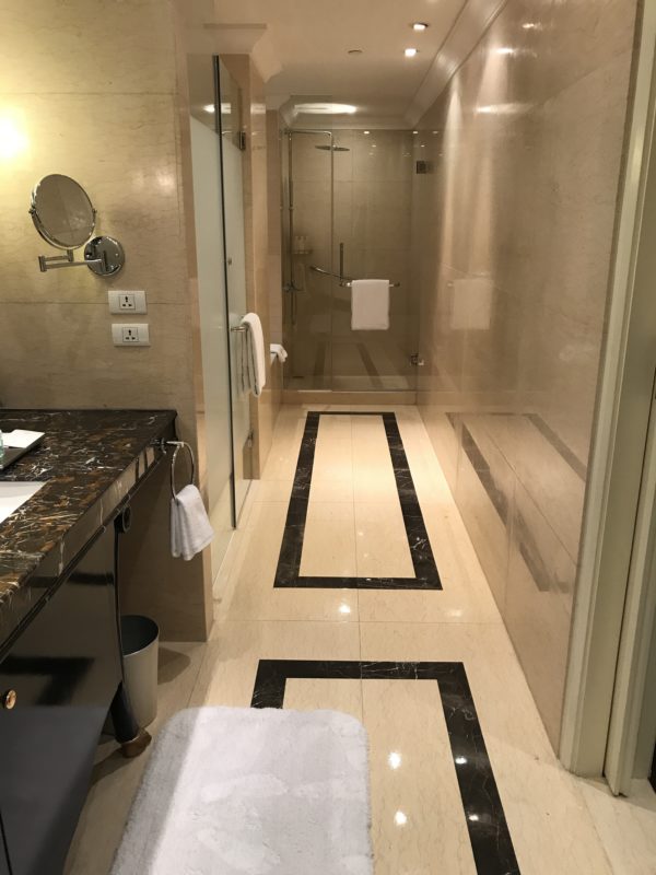 a long hallway of a luxurious bathroom